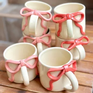 the delightful Ceramic Ribbon Mug, handcrafted for durability and charm, featuring an adorable pink ribbon handle, the perfect gift for her