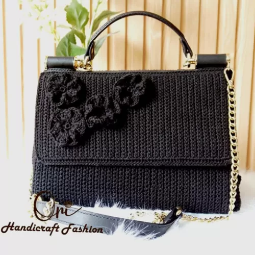 black flower-studded leather bag, delicate chain strap, luxurious and refined design, style of the modern woman