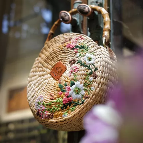 sakura water hyacinth bag, high attention to detail, hand-embroidered patterns, circular crossbody bag, fashionable outfit accent