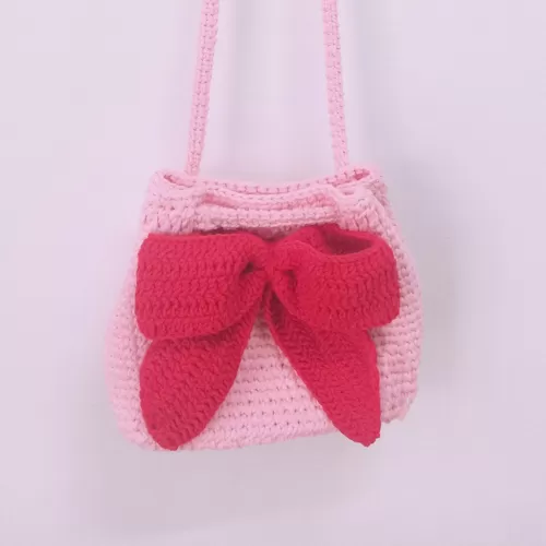 baby pink crocheted bag with pink bow tie, sweet color tone, gentle and cute style, a gift for feminine girls