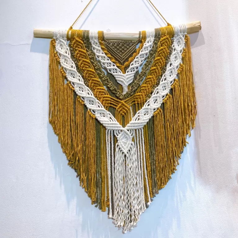 yellow macrame wall hanging, exquisite knots, warm tone, harmonious colors, elaborate design, durable material