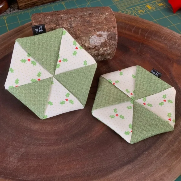 The Set of 2 Hexagonal Coasters features a bright color palette and artistic fabric design, making them perfect for festive decor, a thoughtful handmade gift, or the ideal Christmas gift